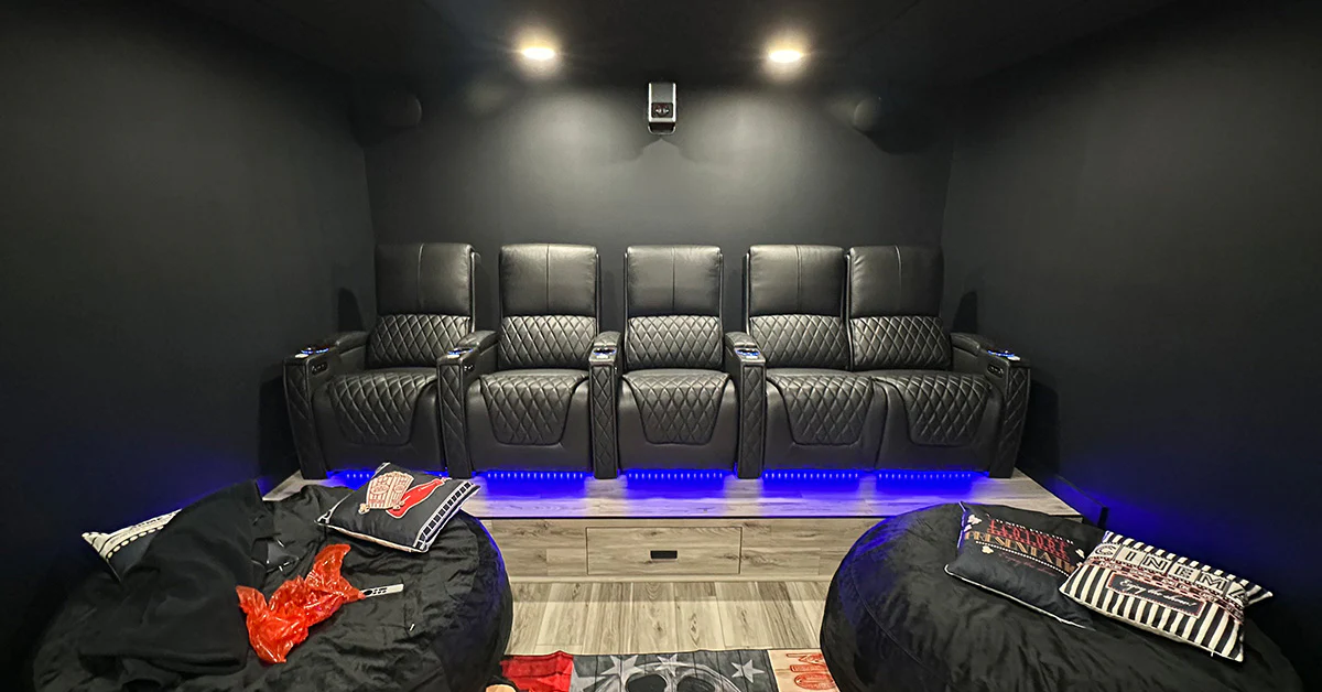 Modern luxury home theater with Weilianda leather seating featuring diamond quilted pattern and blue LED lighting