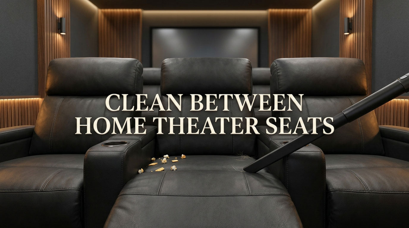 Home theater recliners with crumbs in seat gaps and a crevice vacuum tool ready for cleaning