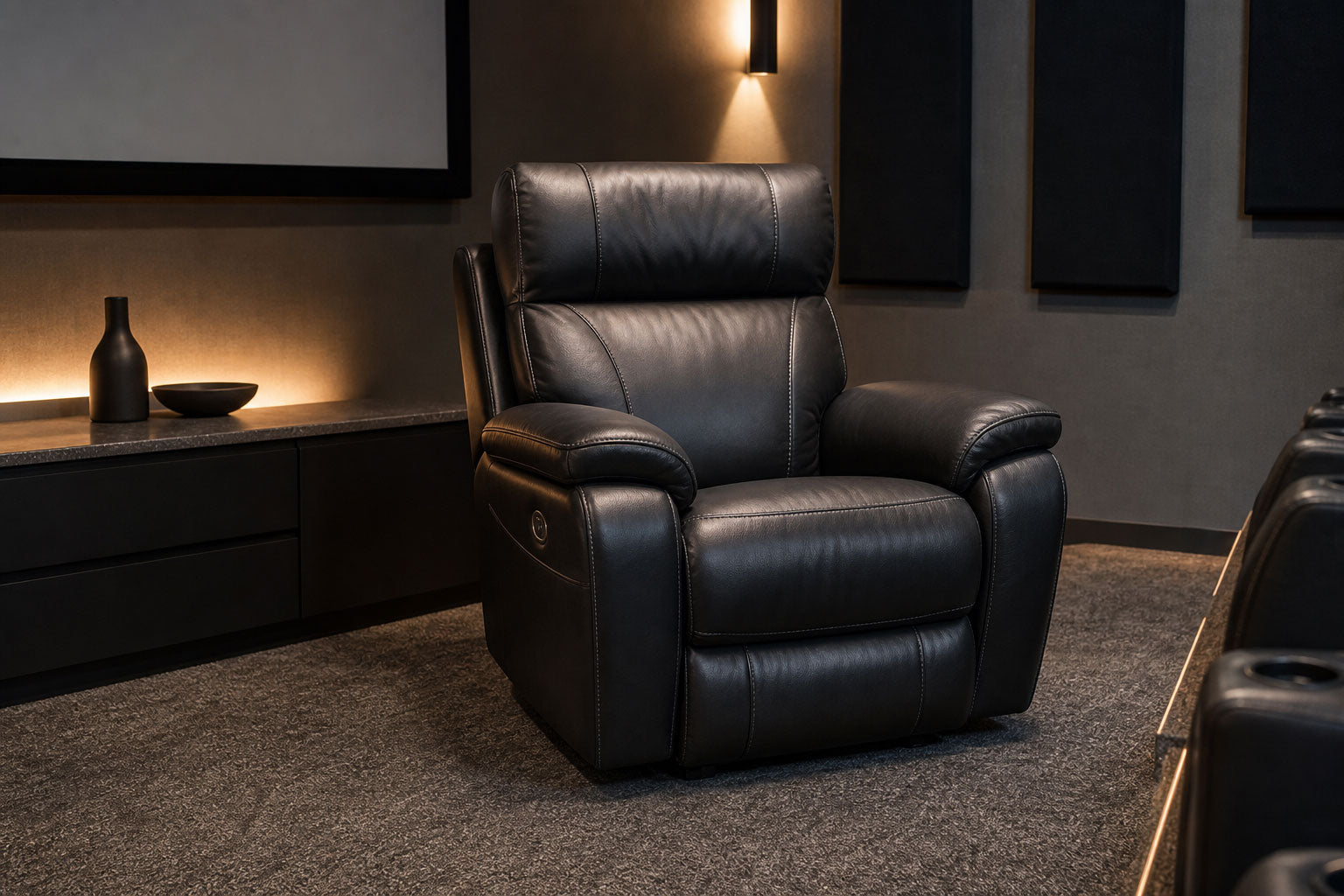 Black leather power recliner in a modern home theater