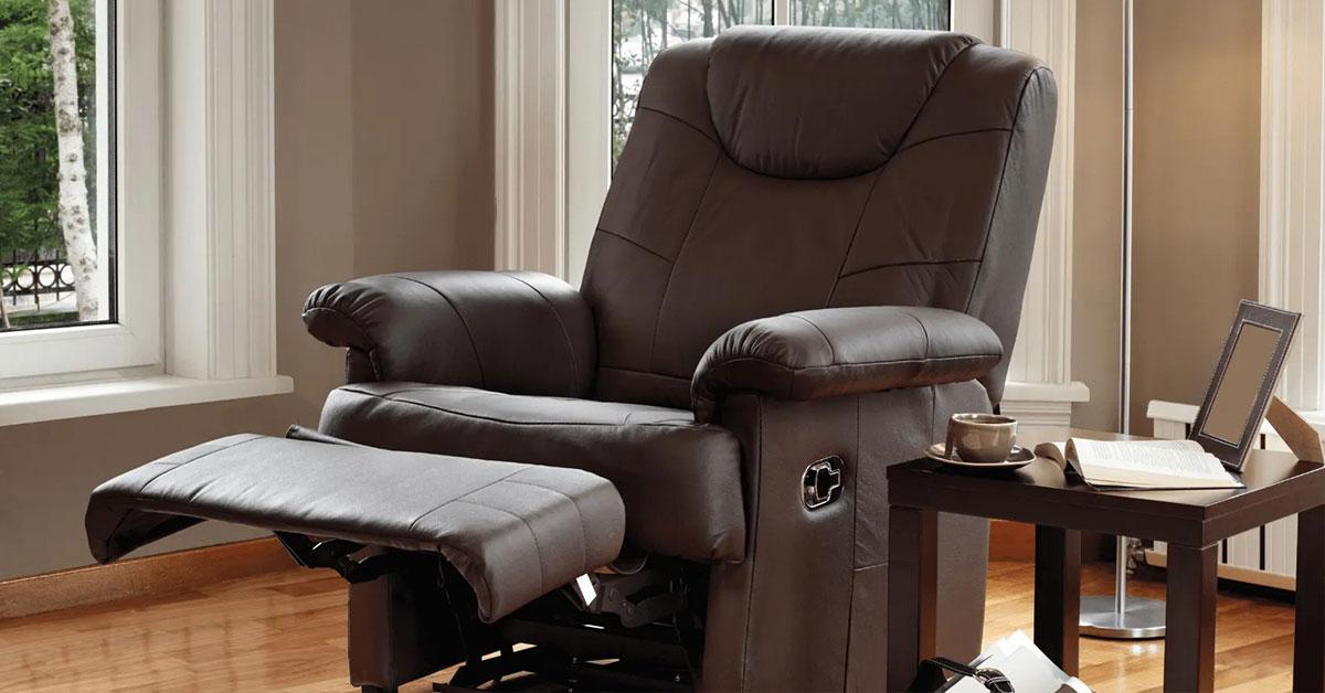 Brown leather recliner chair with footrest extended in a cozy living room setting