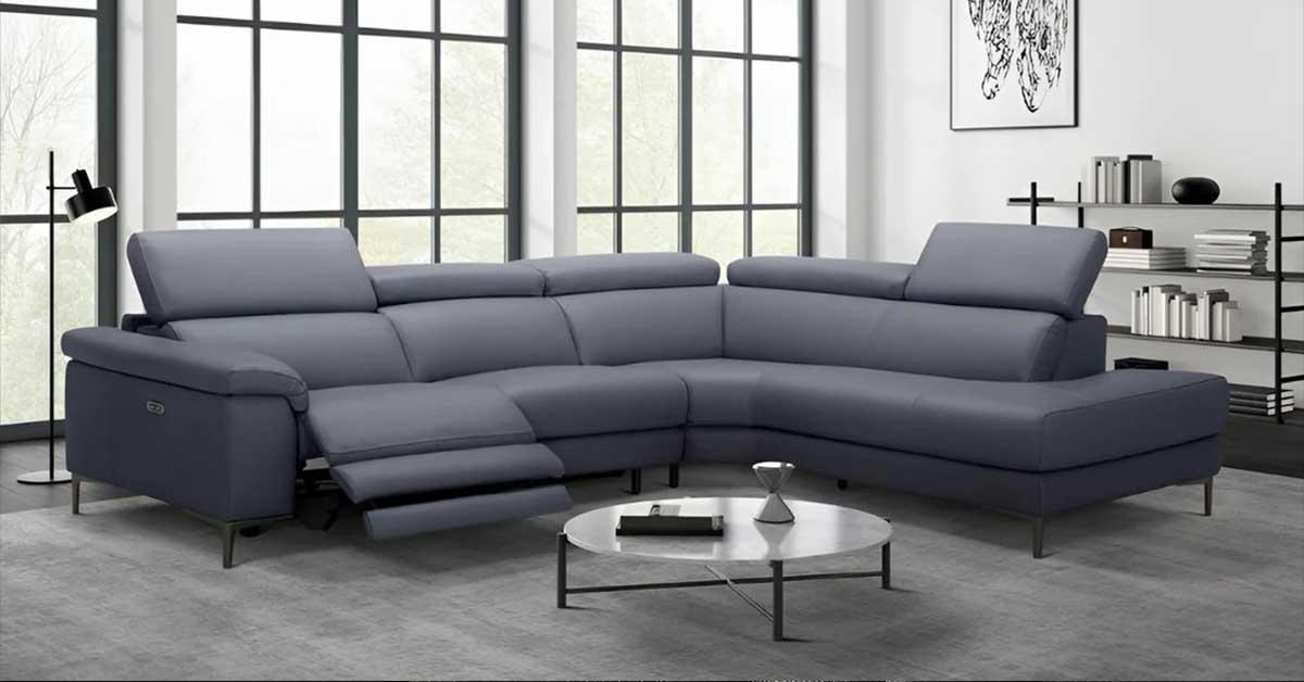 L shaped leather sectional with matching ottoman in a modern living room