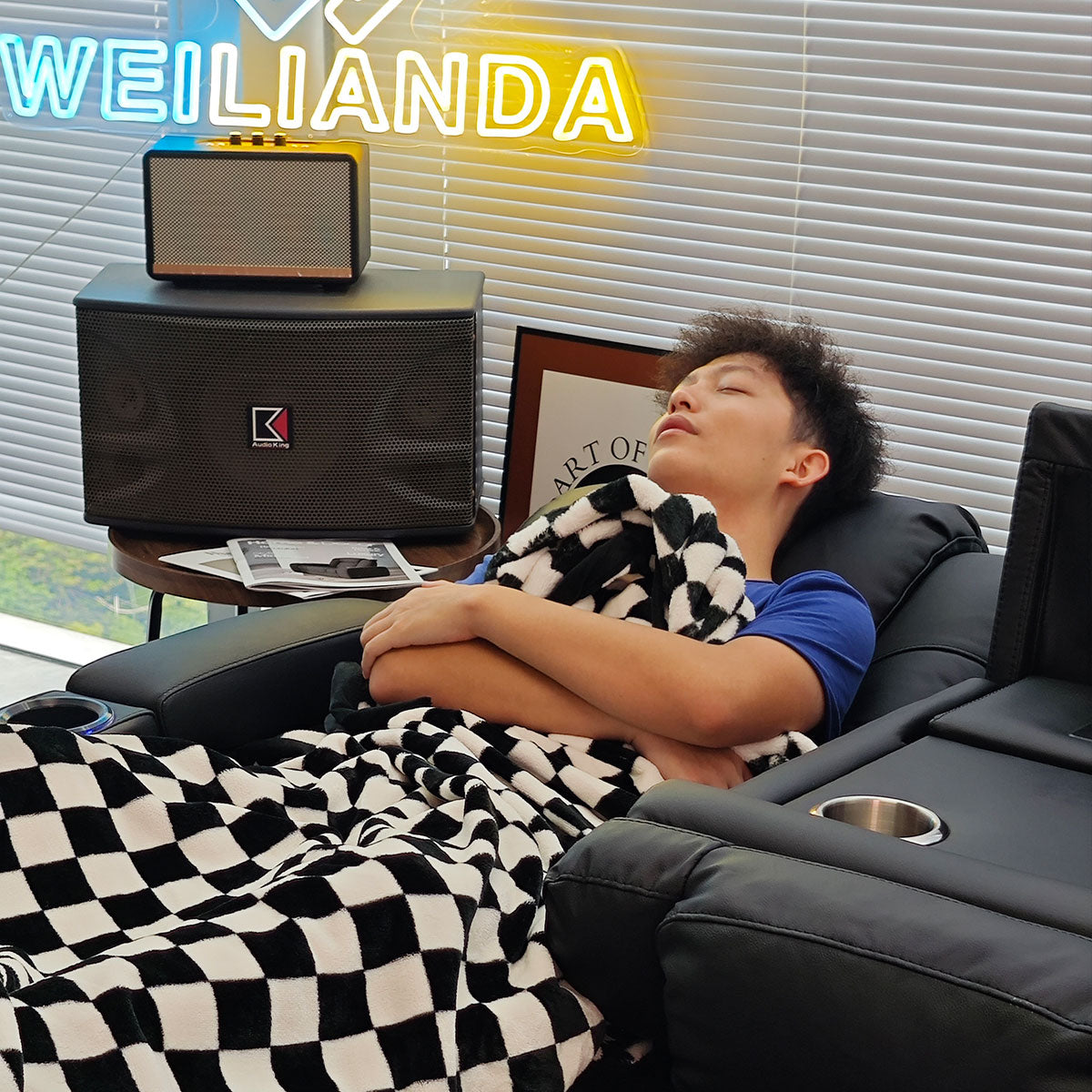 Man sleeping comfortably in a fully reclined home theater chair.