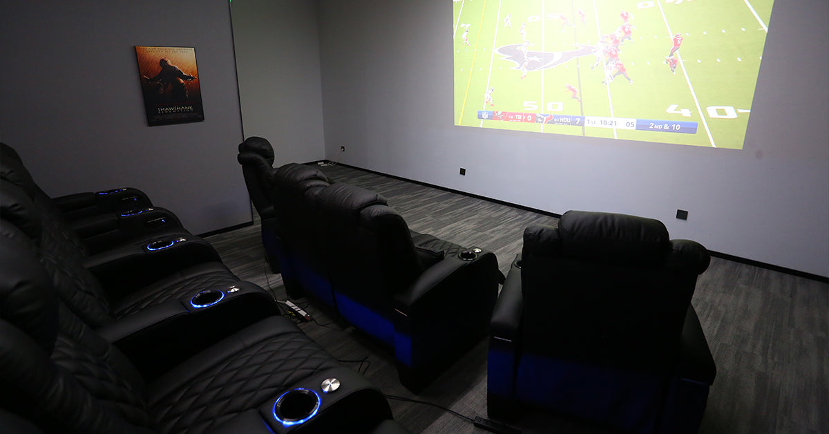 Multi row home theater recliner seating setup with projector screen