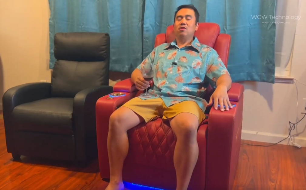 Man relaxing on a red home theater recliner with LED floor lighting