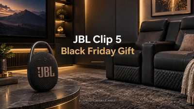 JBL Clip 5 speaker beside home theater seating in a contemporary media room.
