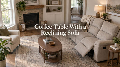 A reclining sofa faces a narrow oval coffee table, with open floor around the extended footrest and a separate side table.