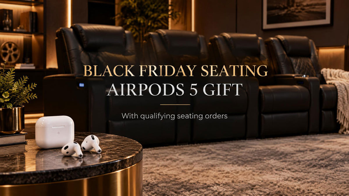 AirPods earbuds beside reclining theater seats in a warmly lit home theater