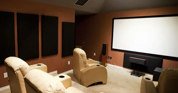 Home theater with beige recliner chairs, wall acoustic panels, and a large projector screen.