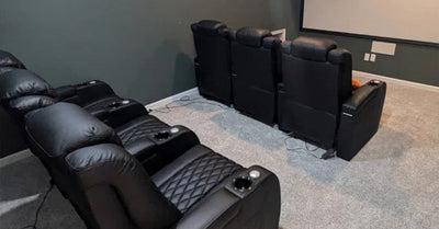 A home theater setup with plush reclining chairs and a large projection screen, creating an immersive entertainment experience.