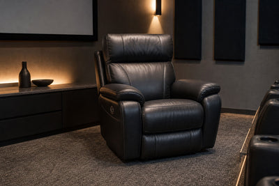 Black leather power recliner in a modern home theater