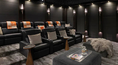 Two rows of black theater seats in a home theater