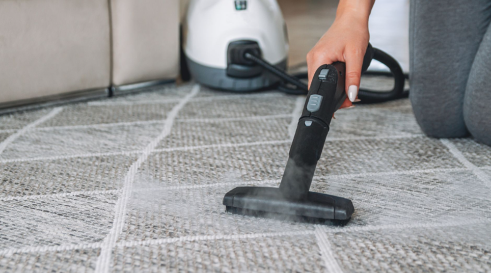 A person vacuuming the carpet in a home theater