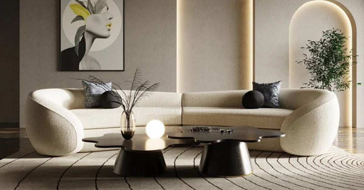 A modern living room with a stylish, curved sofa, decorative pillows, and a minimalist coffee table.