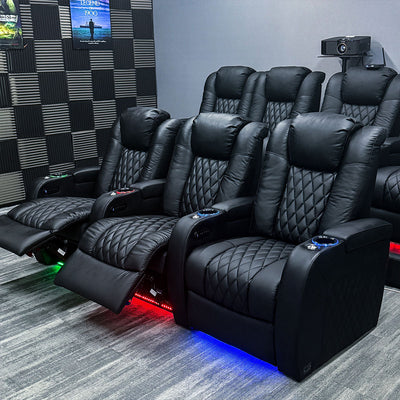 Row of leather home theater recliners with ambient LED lighting.