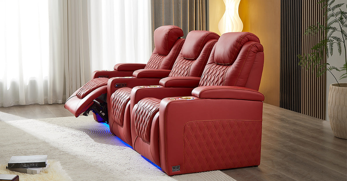 Three red reclining theater seats with LED base lighting in a modern home entertainment room.