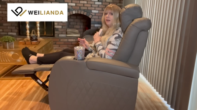 Woman reviewing a gray recliner with Weilianda logo visible