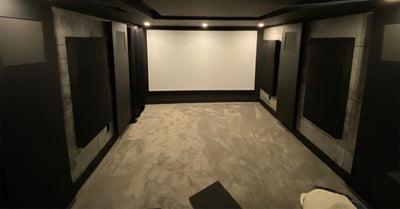 Modern home theater room with projector screen and acoustic wall panels