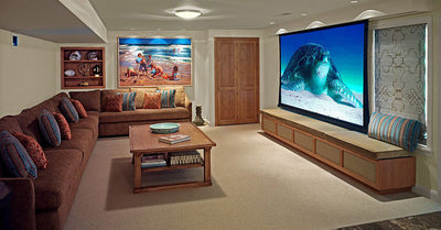 Cozy home theater with large projector screen and sectional sofa