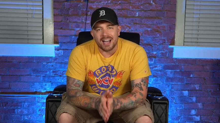 Man presenting in front of a home theater recliner with blue backlighting