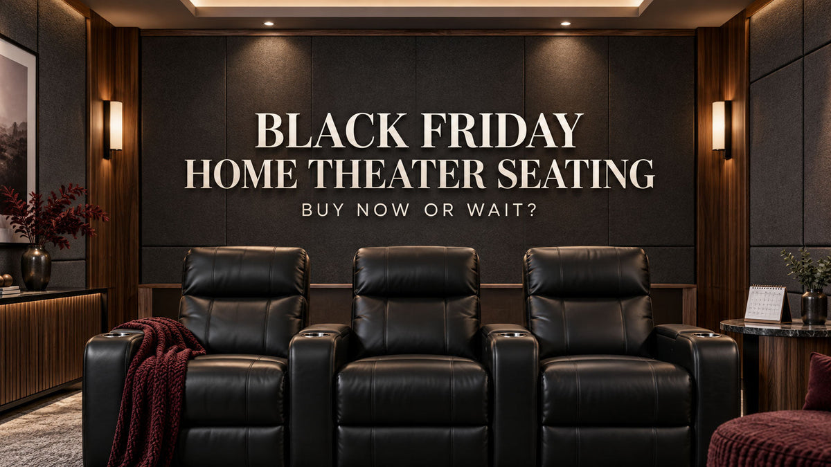 Three leather theater seats in a modern media room with a calendar on a side table.